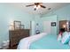 This bedroom boasts wood floors, a large dresser and easy access to a full bathroom at 312 Barrington Ct, Spring Hill, FL 34609