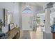 Bright foyer boasts tile floors, transom window, and neutral paint, creating a welcoming entrance at 312 Barrington Ct, Spring Hill, FL 34609