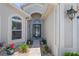 Inviting front entrance with a decorative glass door and landscaped walkway at 312 Barrington Ct, Spring Hill, FL 34609