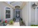 Inviting front entry with decorative stonework and colorful garden beds at 312 Barrington Ct, Spring Hill, FL 34609