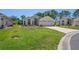 Well-maintained single-story home with a lush green lawn and patterned concrete driveway at 312 Barrington Ct, Spring Hill, FL 34609