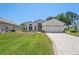 Charming single-story home featuring a well-manicured lawn and a patterned concrete driveway at 312 Barrington Ct, Spring Hill, FL 34609