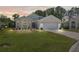 Charming home featuring a well-manicured lawn, a two-car garage, and attractive landscaping at 312 Barrington Ct, Spring Hill, FL 34609