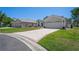 Beautiful front exterior showcasing a well-maintained lawn and patterned concrete driveway at 312 Barrington Ct, Spring Hill, FL 34609