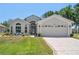 Charming single-story home featuring a well-manicured lawn and a two-car garage at 312 Barrington Ct, Spring Hill, FL 34609