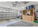 Spacious garage with organized storage, a work bench, and a ceiling fan for added comfort at 312 Barrington Ct, Spring Hill, FL 34609