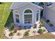 Decorative garden with gravel bed, mature plants, and an arched window accent at 312 Barrington Ct, Spring Hill, FL 34609