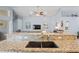 Open-concept kitchen with island and granite countertops, connecting to living space at 312 Barrington Ct, Spring Hill, FL 34609
