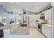 Bright kitchen features granite counters, stainless appliances, and white cabinetry at 312 Barrington Ct, Spring Hill, FL 34609