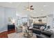 Open-concept living room flows into a modern kitchen with white cabinets and stainless steel appliances at 312 Barrington Ct, Spring Hill, FL 34609