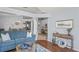 Open-concept living room with hardwood floors, cozy seating, and views into dining area at 312 Barrington Ct, Spring Hill, FL 34609