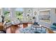 Cozy living room with large windows, plush seating, and hardwood floors at 312 Barrington Ct, Spring Hill, FL 34609