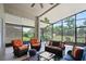 Relaxing screened patio featuring comfortable seating and a ceiling fan for outdoor enjoyment at 312 Barrington Ct, Spring Hill, FL 34609