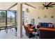 Screened-in patio with comfortable seating, ceiling fan, and view of the backyard at 312 Barrington Ct, Spring Hill, FL 34609