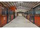 Barn interior with multiple stalls and a bright, airy ceiling with ample natural light at 3431 Saturn Rd, Brooksville, FL 34604