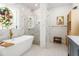 Bright bathroom featuring a standalone tub, glass shower, and unique stained glass window at 3431 Saturn Rd, Brooksville, FL 34604