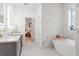 Beautiful primary bathroom featuring double sinks and a soaking tub with marble tile surround at 3431 Saturn Rd, Brooksville, FL 34604