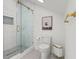 Modern bathroom with glass shower, patterned floors, and gold fixtures, towel rack, and accessories at 3431 Saturn Rd, Brooksville, FL 34604