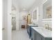 Modern bathroom with double vanity, marble counters, and marble enclosed shower at 3431 Saturn Rd, Brooksville, FL 34604