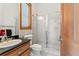 Compact bathroom with a glass shower, vanity, and window, maximizing space and functionality at 3431 Saturn Rd, Brooksville, FL 34604