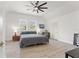 Bright bedroom boasts light-colored floors, two windows, ceiling fan, and recessed lighting at 3431 Saturn Rd, Brooksville, FL 34604