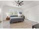 Spacious bedroom with natural light, featuring a ceiling fan and two bright windows at 3431 Saturn Rd, Brooksville, FL 34604