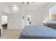 Bright bedroom features a large window, light-colored floors, closet, and ensuite bathroom entrance at 3431 Saturn Rd, Brooksville, FL 34604