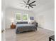 Bright bedroom boasts light-colored floors, two windows, ceiling fan, and recessed lighting at 3431 Saturn Rd, Brooksville, FL 34604