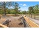 Open-air bird pen featuring wire and wooden fence, with emus roaming on the dirt ground at 3431 Saturn Rd, Brooksville, FL 34604