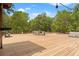 Expansive wood deck featuring outdoor dining and grilling area, perfect for entertaining amid a lush, wooded landscape at 3431 Saturn Rd, Brooksville, FL 34604
