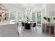 Charming dining area with an elegant chandelier, large windows, and stylishly set table with seating for six at 3431 Saturn Rd, Brooksville, FL 34604