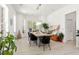 Bright dining area with a large table, modern lighting, and natural light from bay windows at 3431 Saturn Rd, Brooksville, FL 34604