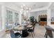 Tastefully decorated dining area with French doors, modern chandelier, and direct view into the living room at 3431 Saturn Rd, Brooksville, FL 34604