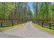 Long, private driveway lined with trees and fencing, leading to a gated entrance, offering seclusion and security at 3431 Saturn Rd, Brooksville, FL 34604