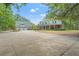 Sprawling estate with lush landscaping, a long driveway, and a charming home featuring a welcoming front porch at 3431 Saturn Rd, Brooksville, FL 34604