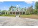 Beautiful brick home with a metal roof and sprawling front porch, set on a spacious lot at 3431 Saturn Rd, Brooksville, FL 34604