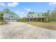 Expansive property featuring a main house and detached garage, connected by a long driveway at 3431 Saturn Rd, Brooksville, FL 34604