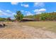 Expansive farm with a beautiful landscape, including green fields and farm buildings at 3431 Saturn Rd, Brooksville, FL 34604