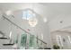 Bright, high-ceilinged foyer with glass-railed staircase and modern chandelier at 3431 Saturn Rd, Brooksville, FL 34604