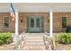 Elegant entrance with double doors, sidelights, stone steps, and brick columns at 3431 Saturn Rd, Brooksville, FL 34604