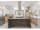 Modern kitchen with custom wood cabinets, a sizable island, and stainless steel appliances under abundant natural light at 3431 Saturn Rd, Brooksville, FL 34604