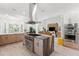 Bright, modern kitchen featuring a central island with marble countertop and stainless steel appliances at 3431 Saturn Rd, Brooksville, FL 34604