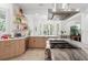 Well-lit kitchen with custom wood cabinetry, open shelving, and a stainless steel range with hood at 3431 Saturn Rd, Brooksville, FL 34604