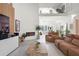 Bright living room with a fireplace, comfortable seating, and an open floor plan connecting to the entryway and dining area at 3431 Saturn Rd, Brooksville, FL 34604