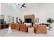 Large living room boasts high ceilings, clerestory windows, wood accents, and ample seating facing the entertainment center and fireplace at 3431 Saturn Rd, Brooksville, FL 34604