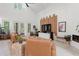Spacious living room with modern decor, fireplace, custom wood accent wall, and a wall of windows leading to the yard at 3431 Saturn Rd, Brooksville, FL 34604