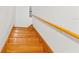 Elegant wooden staircase with light-colored walls leading to the upper level, offering a classic design at 3431 Saturn Rd, Brooksville, FL 34604