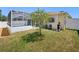 Landscaped backyard featuring well-maintained lawn and a screened-in patio, offering a comfortable outdoor living space at 4321 High Ridge Ave, Spring Hill, FL 34609