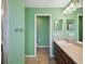 Bright bathroom featuring a vanity with a sink, a mirror, and a doorway leading to another part of the bathroom at 4321 High Ridge Ave, Spring Hill, FL 34609