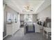 Serene bedroom featuring a tray ceiling, ceiling fan, and plush carpeting at 4321 High Ridge Ave, Spring Hill, FL 34609